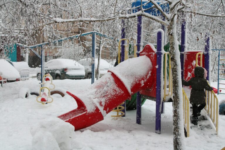 a child playing in the snow at a playground