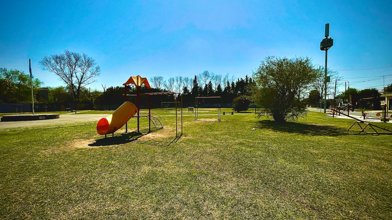 a playground in a park with a slide and swings