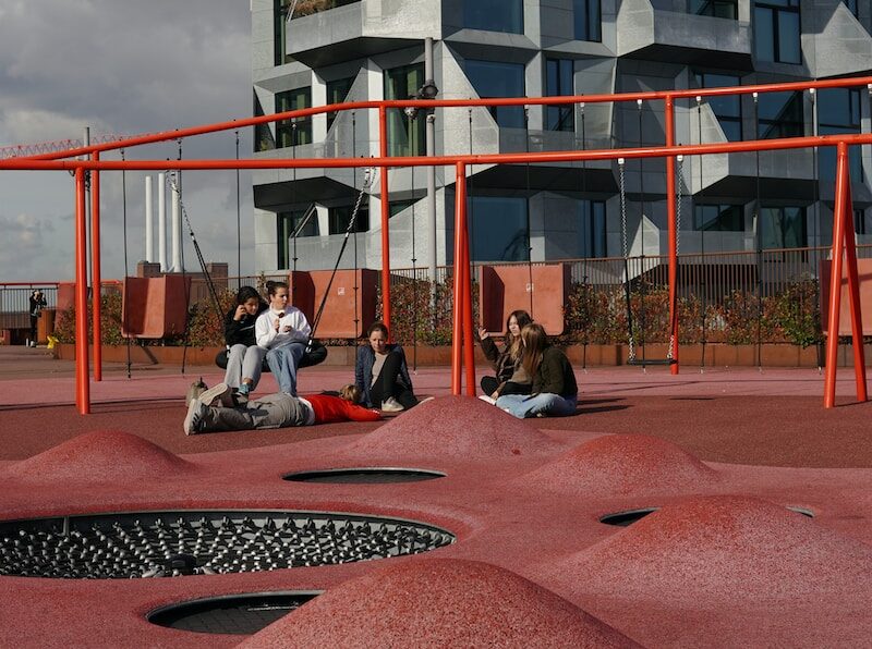 a group of people sitting on top of a playground