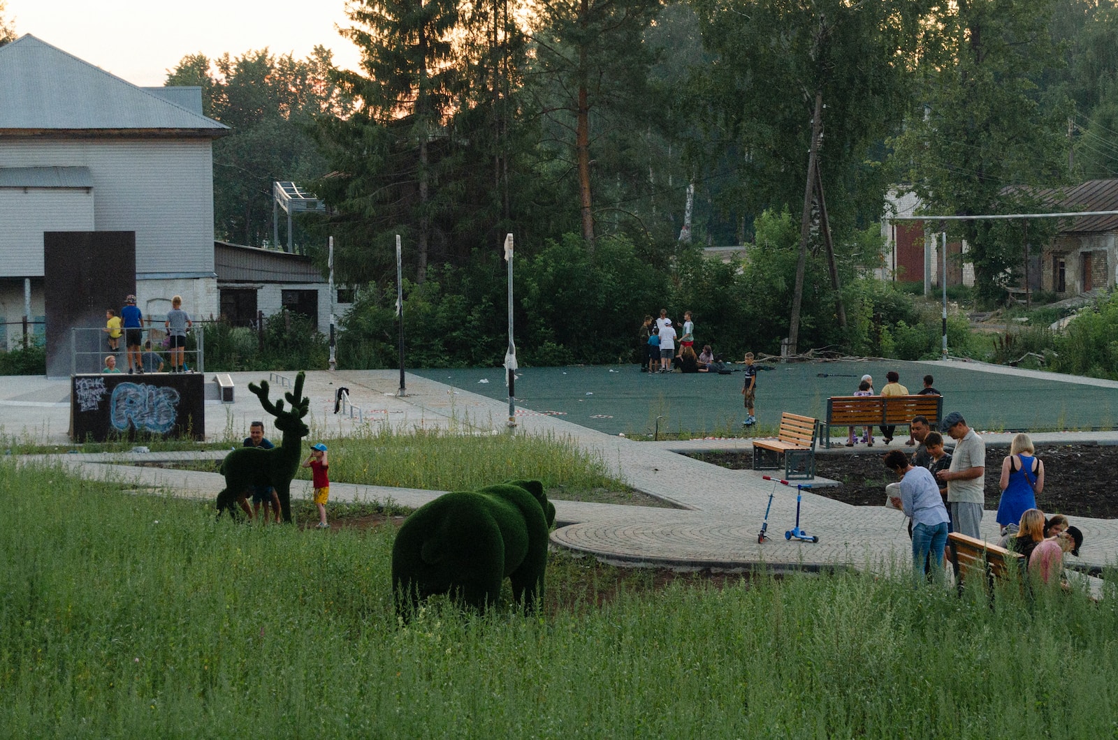 a group of people stand around a park