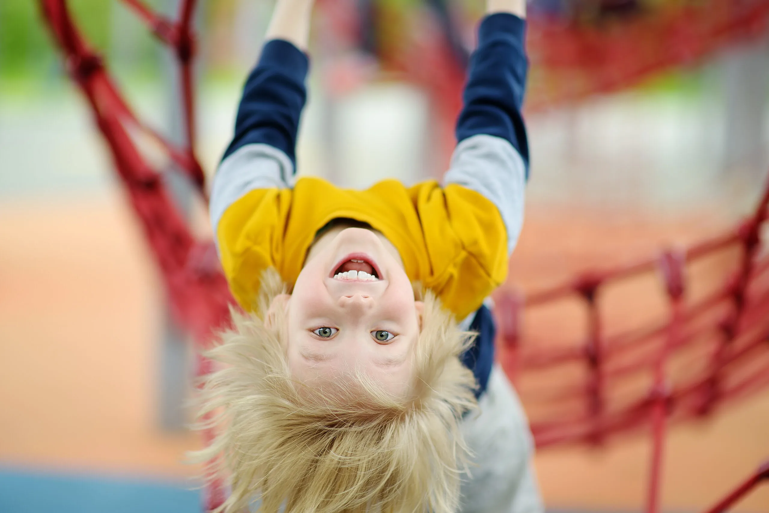 ?ute perky preschooler boy having fun on outdoor playground. spring/summer/autumn active sport leisure for kids. outdoor activities for children.
