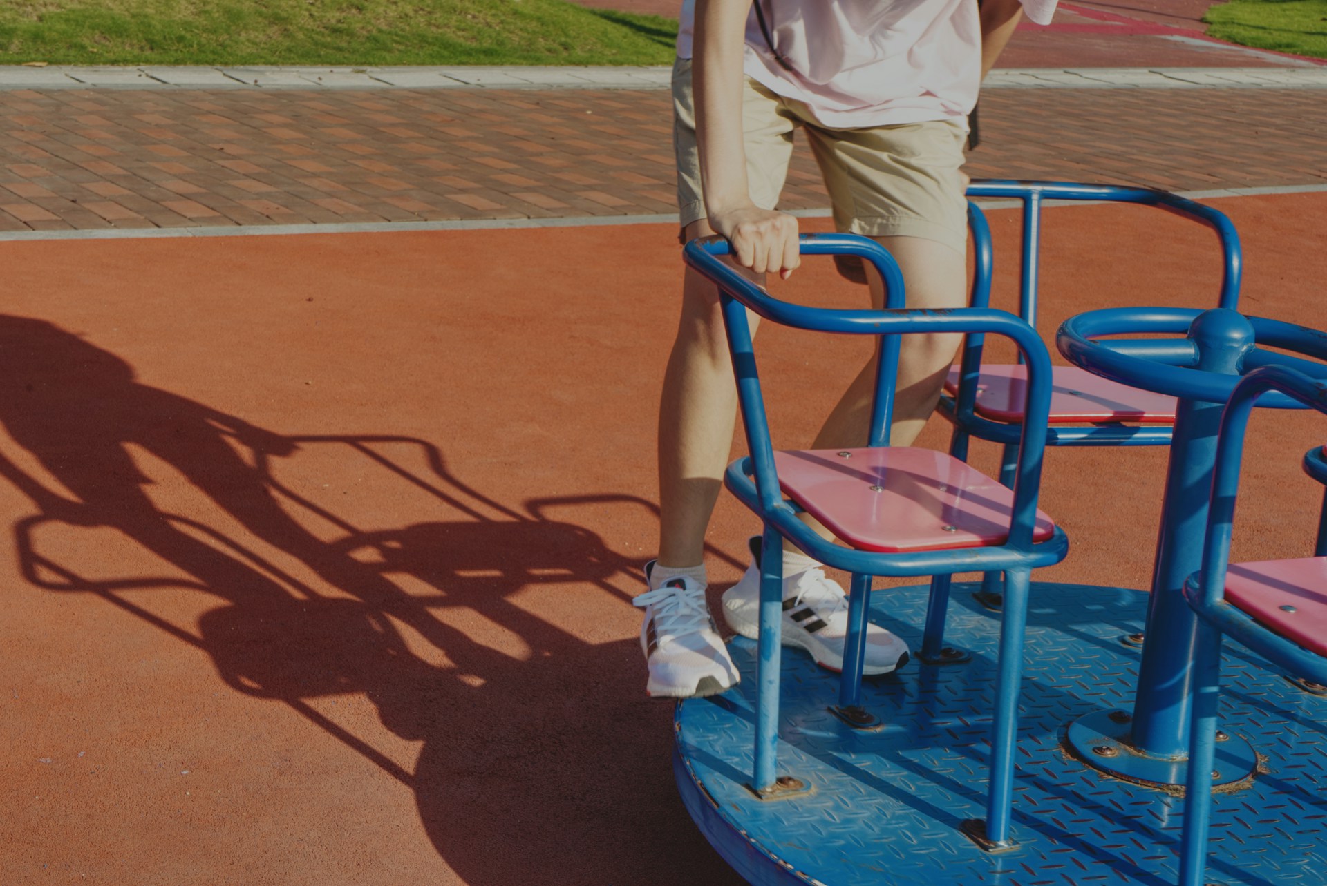 woman in white shirt and blue denim jeans sitting on blue plastic chair