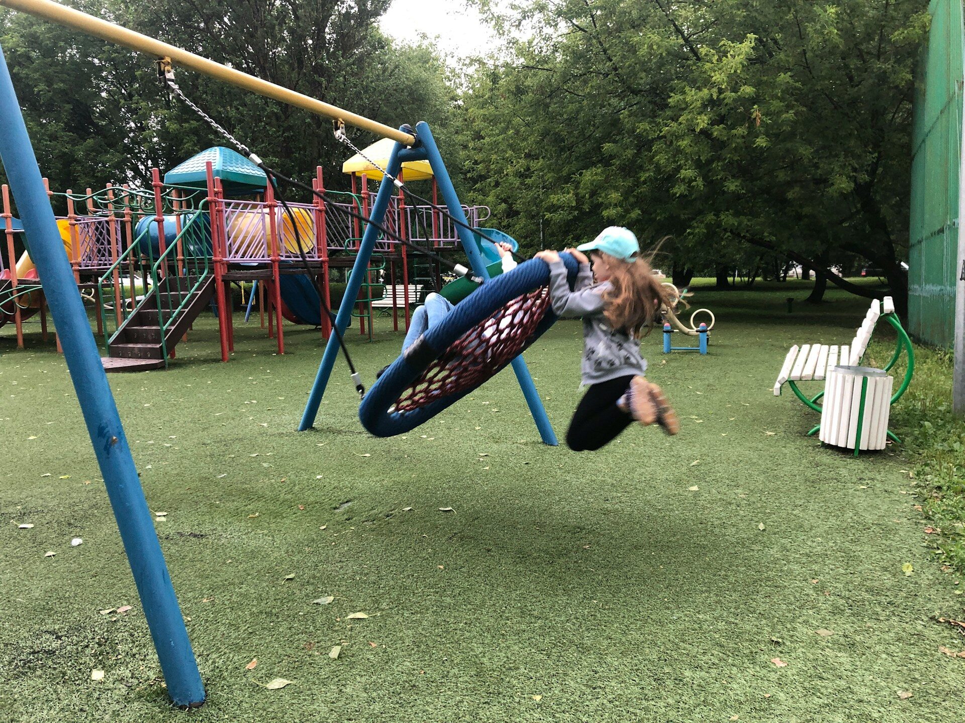 a girl playing on a playground